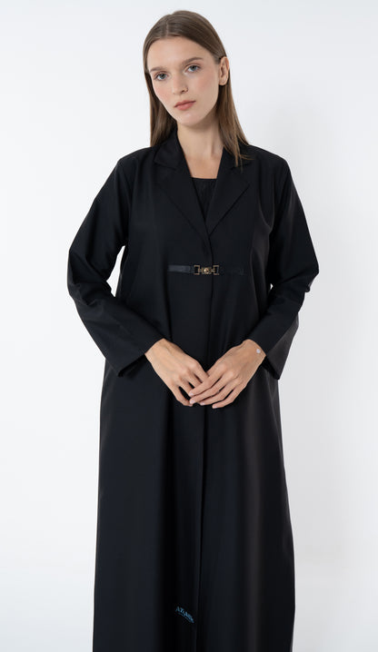 Woman wearing a black abaya on a white background